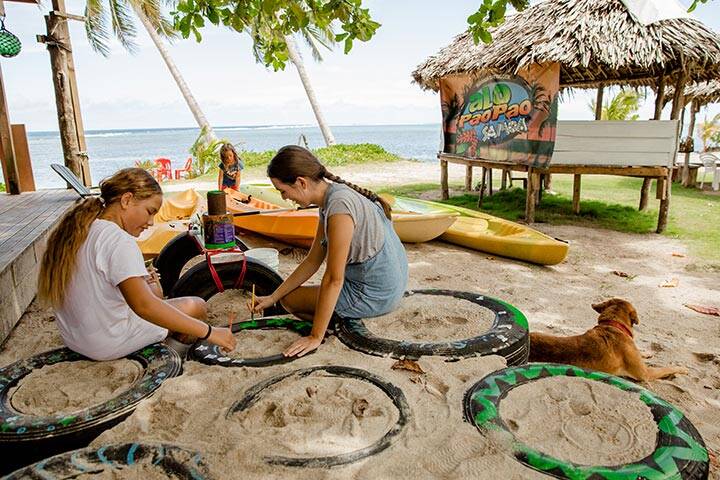 Families painting tires in Samoa