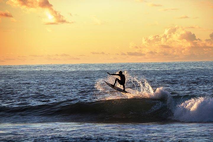 Surfer in Samoa at Sunset