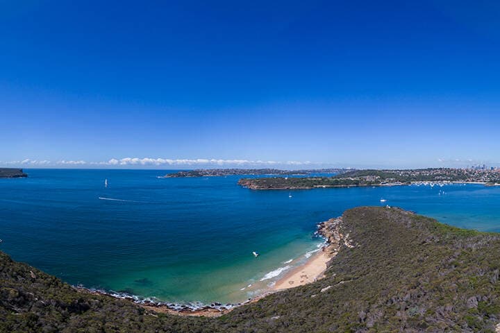 Scenic coastal aerial view across Sydney Harbour from the Spit Bridge to Manly Walk. 