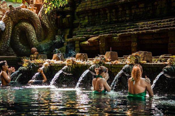 Swimming in the holy water at Tirta Empul Temple Bali by Ismail Hamzah