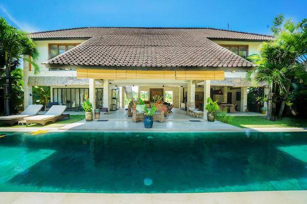 Outdoor dining and lounging area opening up to private pool at the Abaca Luxury Villas, Bali