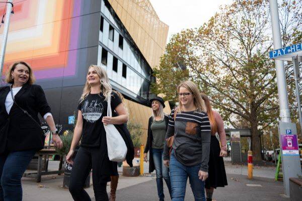 Group of young people walking through the urban streets of Braddon in Canberra 