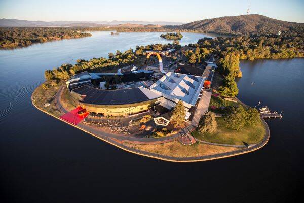  Aerial view of the National Museum of Australia building on the Acton peninsula surrounded by lake