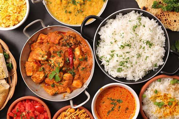 Flat lay of butter chicken, mango beef and rice dishes at Exotic North Indian Cuisine, Darwin.