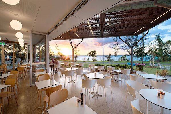 Outdoor seating area with beachfront waterview at The Foreshore Restaurant & Cafe.