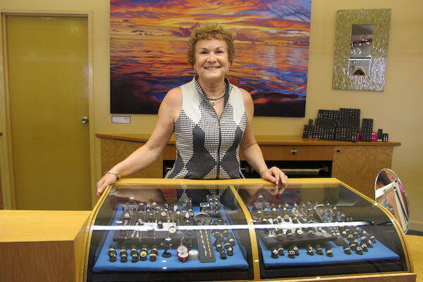 Woman showing diamonds in display cabinet in Kimberley, Western Australia