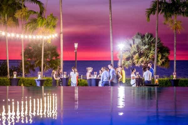 Sunset view of water and resort pool with guests enjoying dusk drinks at Il Piatto Restaurant, Darwin.