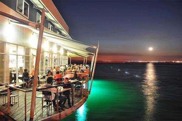 Night time view of deck overlooking water at the Jetty restaurant, Darwin.