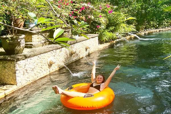 Woman sitting in ring floaty in water at Waterbom, Bali