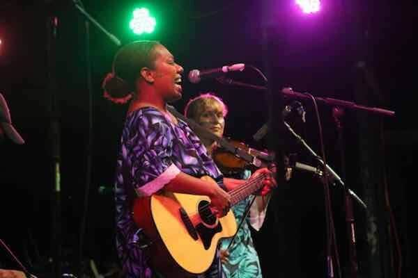 Locals performing on stage singing with guitar for festival, Vanuatu