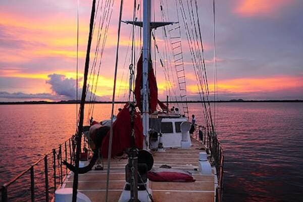 Boat ride over sunset skies along water in Vanuatu