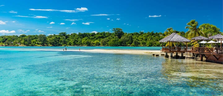 Palm trees and overwater bungalows on a tropical beach, Vanuatu, Erakor Island, Efate