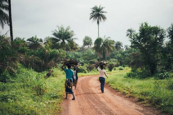 Locals walking on dirt road in village, Vanuatu 
