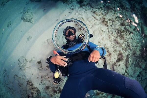 Diver blowing bubbles through mask in ship wreck, Vanuatu 