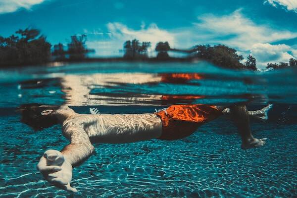 Man floating on back in watering hole, Vanuatu 