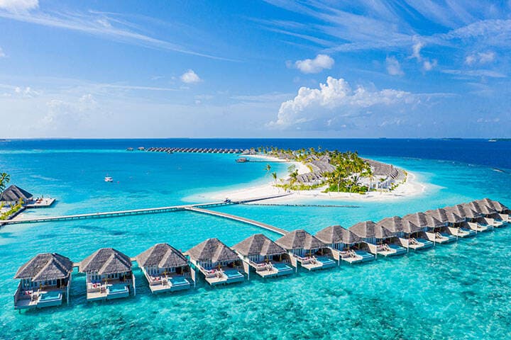 Aerial landscape, of Maldives, with a luxury tropical resort of water villas and beautiful beach scenery