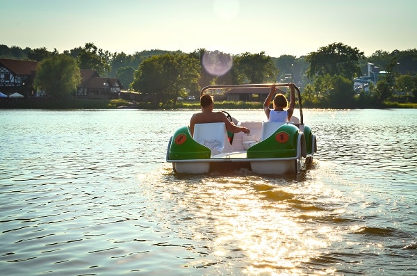Friends using paddle boats