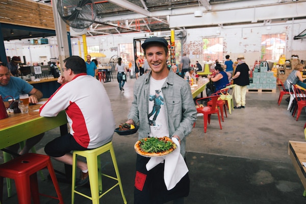 Man with pizza at restaurant