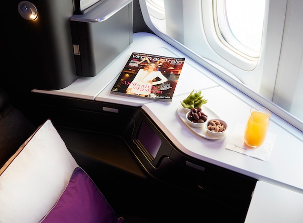 The Business seat with food and Voyeur magazine