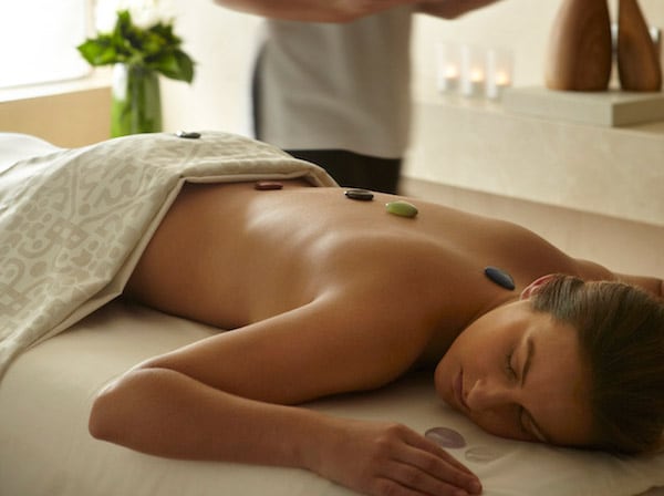 Woman at spa with rocks on back