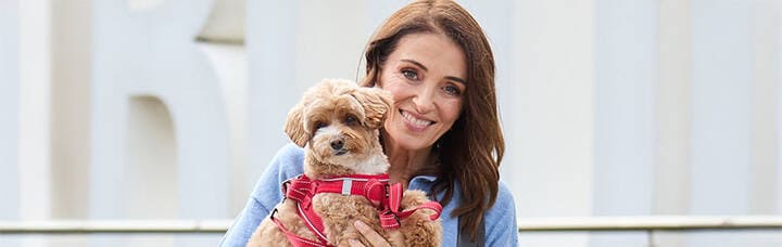 Virgin Australia passenger holding pet at airport.