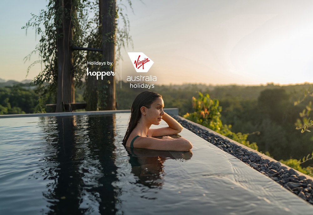 Woman enjoying holiday beside hotel pool.
