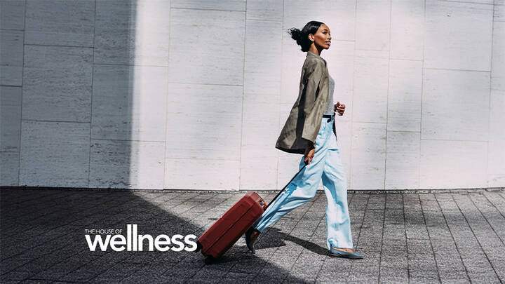 Woman walking with luggage.