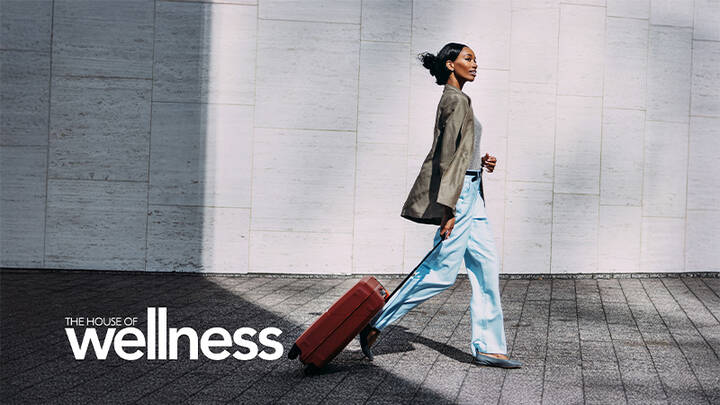 Woman walking with luggage.