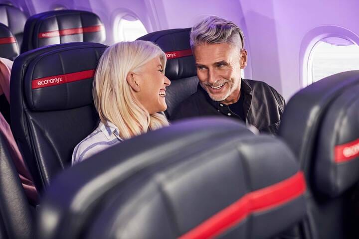 Couple sitting in Virgin Australia economy seating