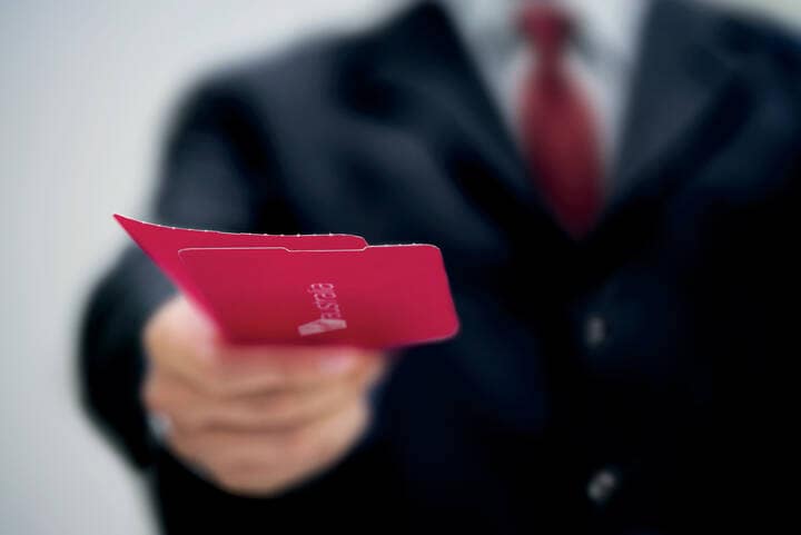 Passenger handing ticket over to guest services after checking in cargo