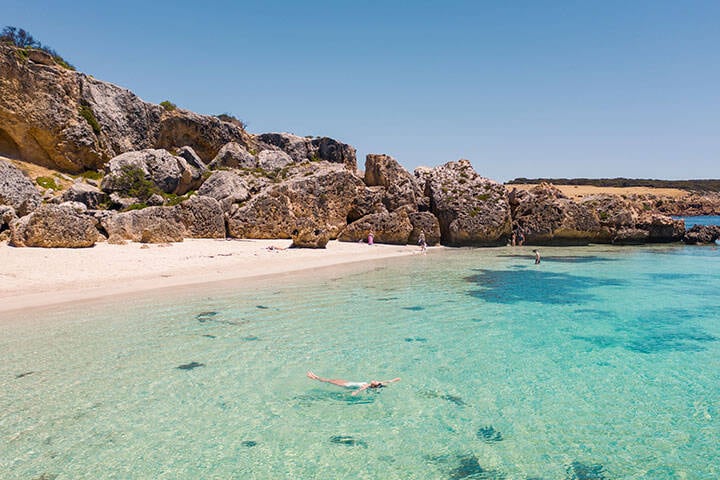 People swimming in the calm waters of Stokes Bay in Kangaroo island