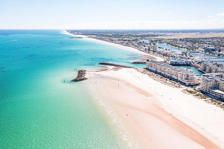 Aerial View Of Turquoise Ocean Water And White Sand At Glenelg Beach In Adelaide, South Australia. 