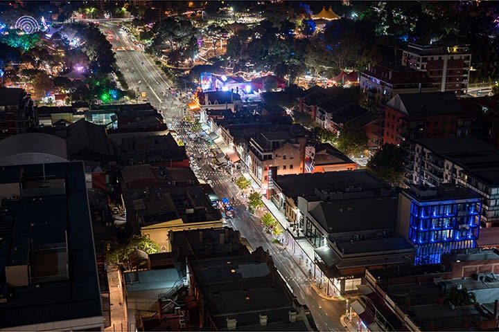 Night time aerial view of Adelaide City's East End Unleashed event with on-street dining and entertainment on Rundle Street, as part of Adelaide Fringe  