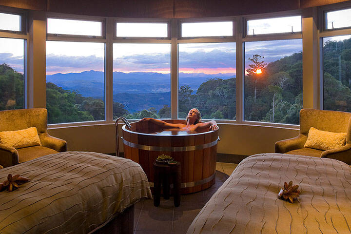 Woman soaking in a spa bath at Lost World Spa in Queensland