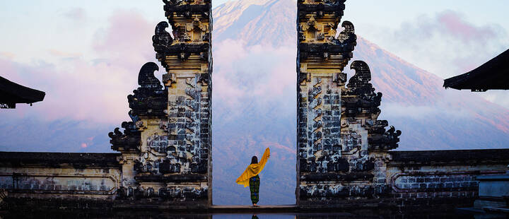 Female tourist at temple gates of heaven in Bali