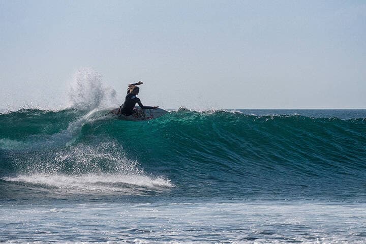 man surfing on sea waves at Suluban Beach during daytime 