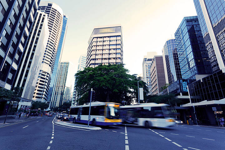 Buses driving through Brisbane city in traffic 