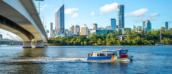 Ferry cruise on Brisbane river with city skyline background 