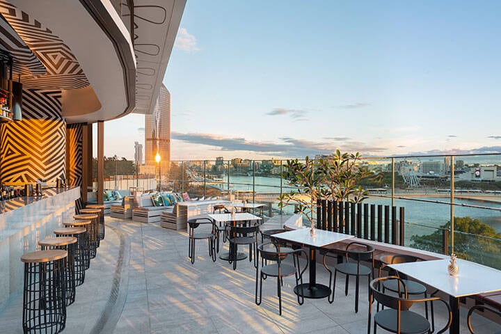 Image of the wet deck terrace showing the view from the bar, tables and lounges. 