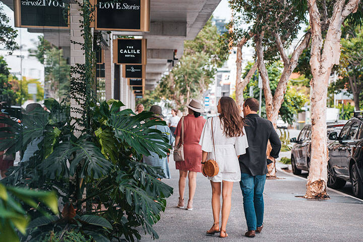 Couple window shopping at The Calile Hotel precinct on James Street