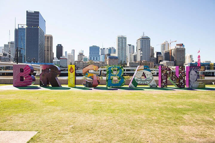 An image of a large Brisbane letter art installation in South Bank in front of the cityscape. 