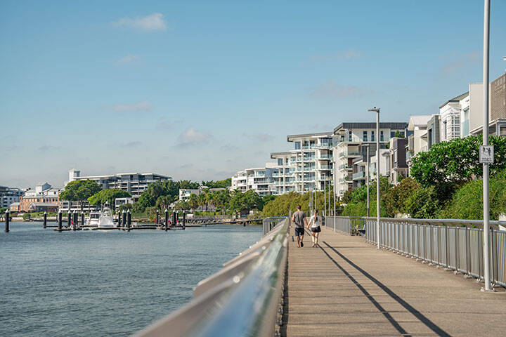 A couple walking along the river in New Farm 
