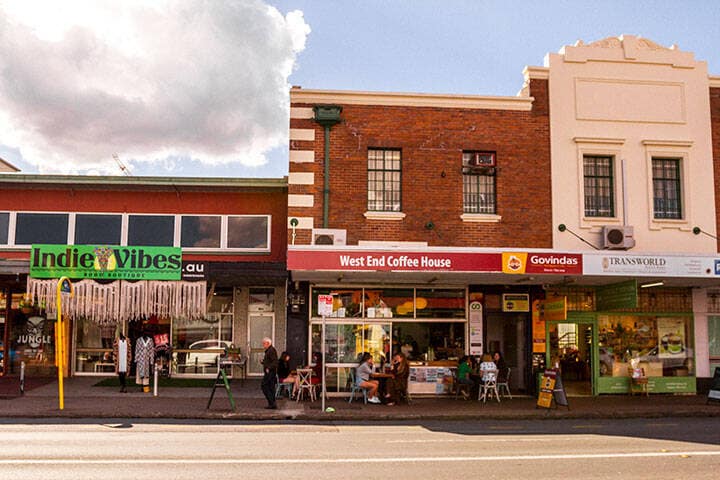 An image of stores on a West End street on a sunny day 