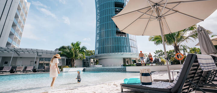 Mother and child swimming at the pool of the Crystalbrook Riley in Cairns