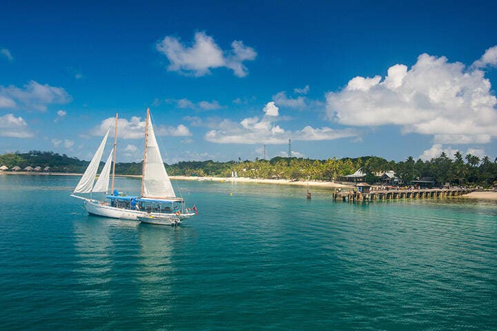 Fiji, Mamanuca islands, Sailing boat anchoring on Mana island  