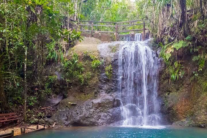 A bench at the end of hiking trail to enjoy a waterfall in Colo-i-Suva rain forest national park, nature reserve near Suva, Viti Levu island, Fiji, Melanesia, Oceania