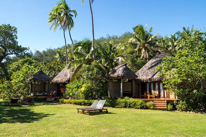 South Pacific Tropical Island Bure Bungalow Deck with Day Bed Looking over Garden, Oceans and Over Water Bure in Fiji