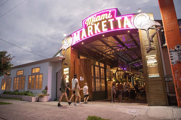 Family walking through entrance of Miami Marketta