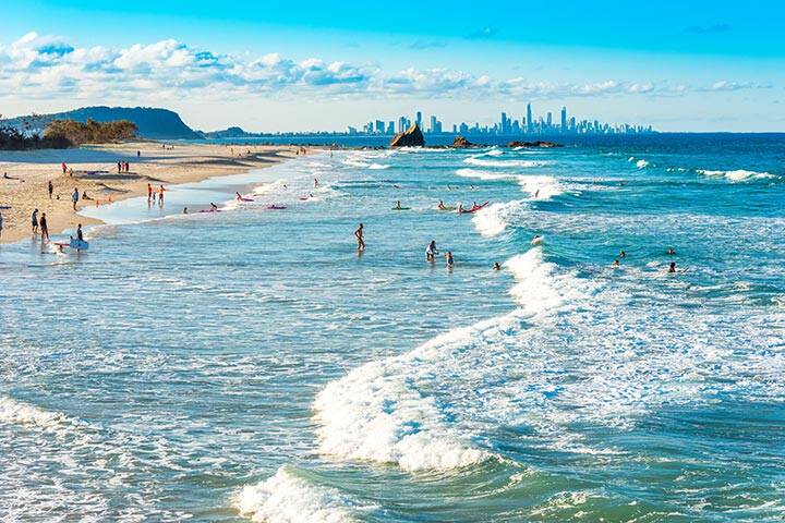 Swimmers and beach goers enjoying the surf and sand in Gold Coast