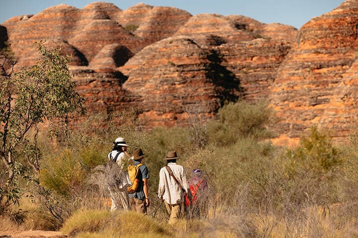 Visitors hiking through Purnululu National Park., towards the beehive domes of the Bungle Bungles